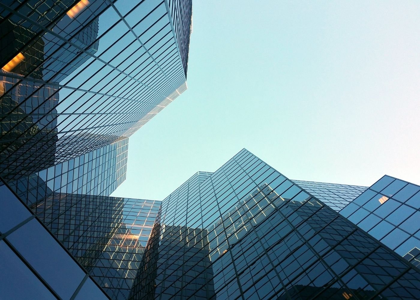 Modern office buildings with glass facades viewed from below